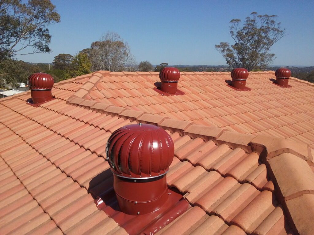 4 red whirlybirds on a orange roof